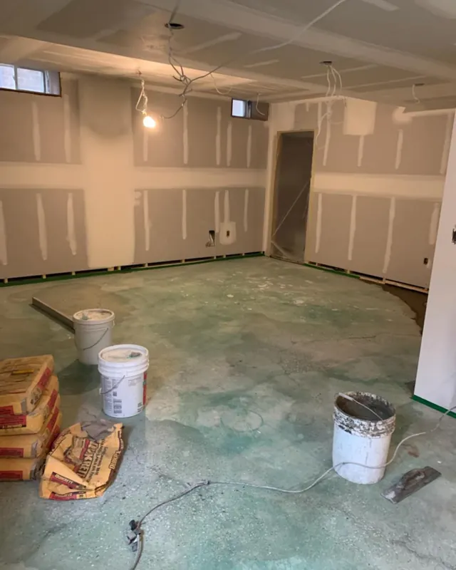 An unfinished basement at drywall stage before fit-out.