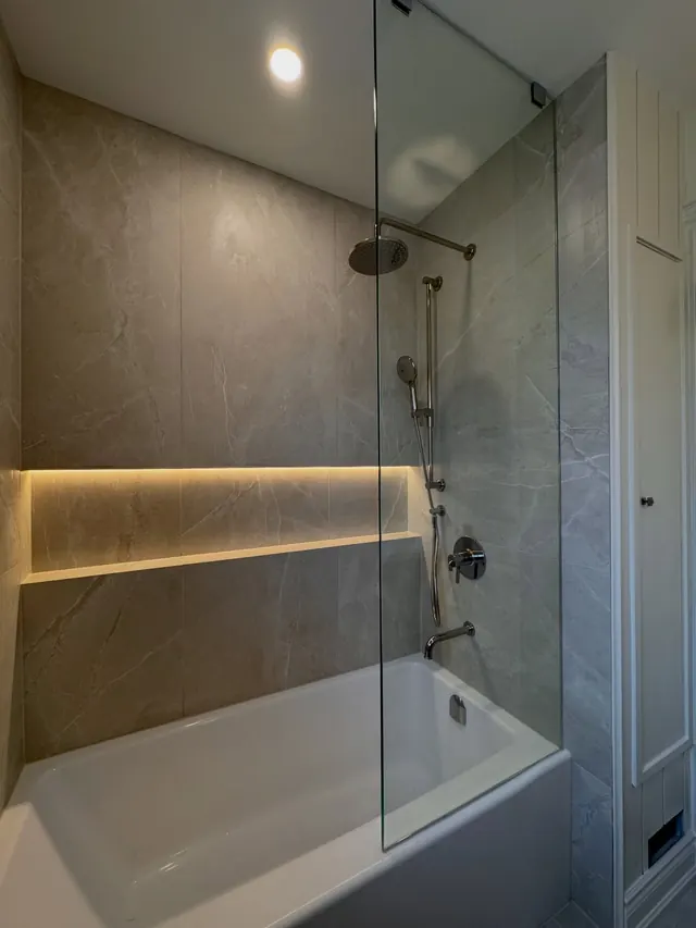 Bath with an illuminated stone niche.