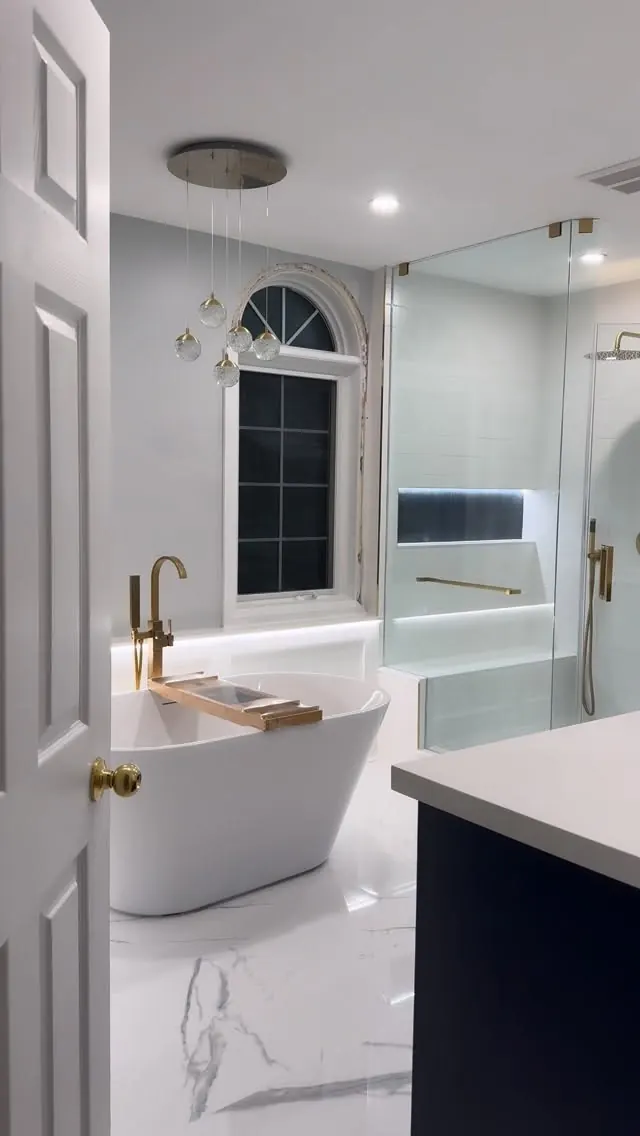 Ensuite with a freestanding bath and brass fittings.