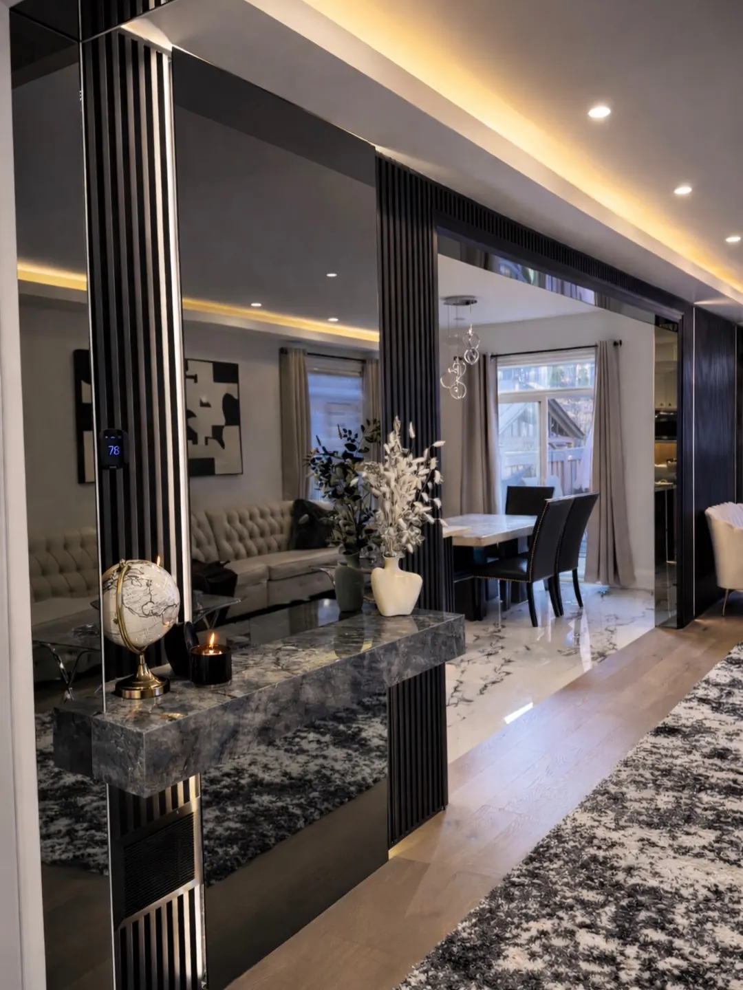 Entrance hall with a stone console table looking through to a dining room.