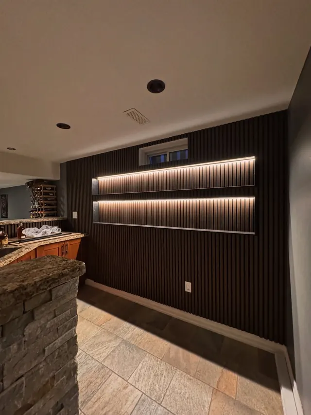 Completed slatted feature wall with concealed lighting and stone.