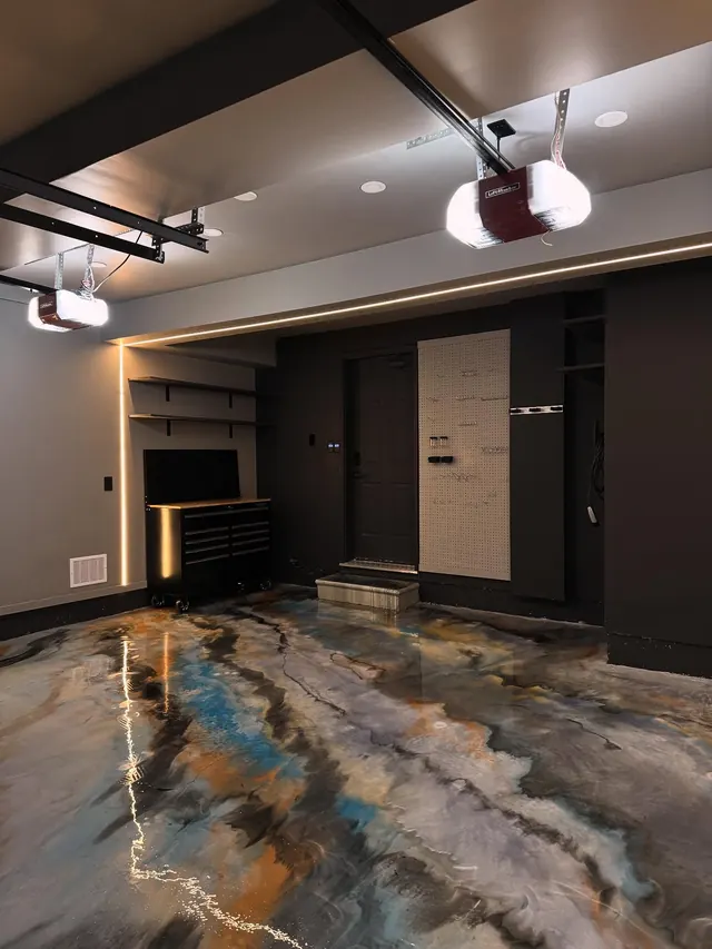 A finished lower-level space with a poured resin floor and dark joinery.