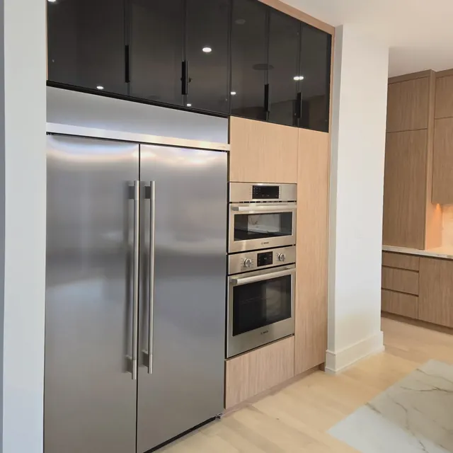 Kitchen with integrated refrigeration and stacked wall ovens.