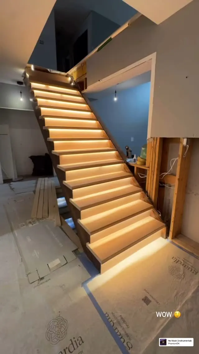 Staircase lit from a concealed cove alongside the treads.