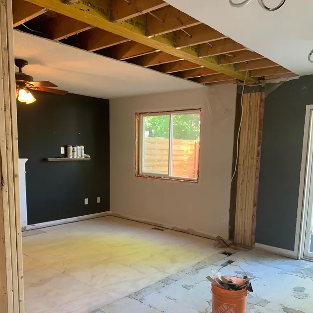A room taken back to studs and joists at the start of a renovation.